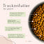 Das FAVLY Petfood-Produkt „Junior Huhn mit Lachs, Apfel & Leinsamen“ bietet Informationen auf Deutsch zu seinen hochwertigen Zutaten und einem innovativen Slow Baking-Verfahren, präsentiert in einer Schüssel.